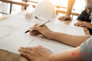 architects_engineer_discussing_at_the_table_with_blueprint_closeup_on_hands_and_project_print_1423_300 (1).jpg